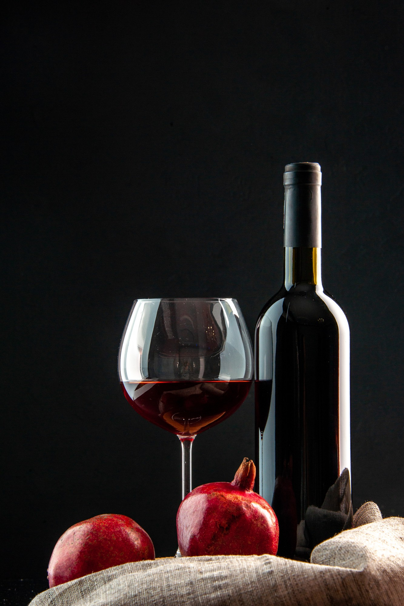 front-view-bottle-wine-with-glass-wine-black-background